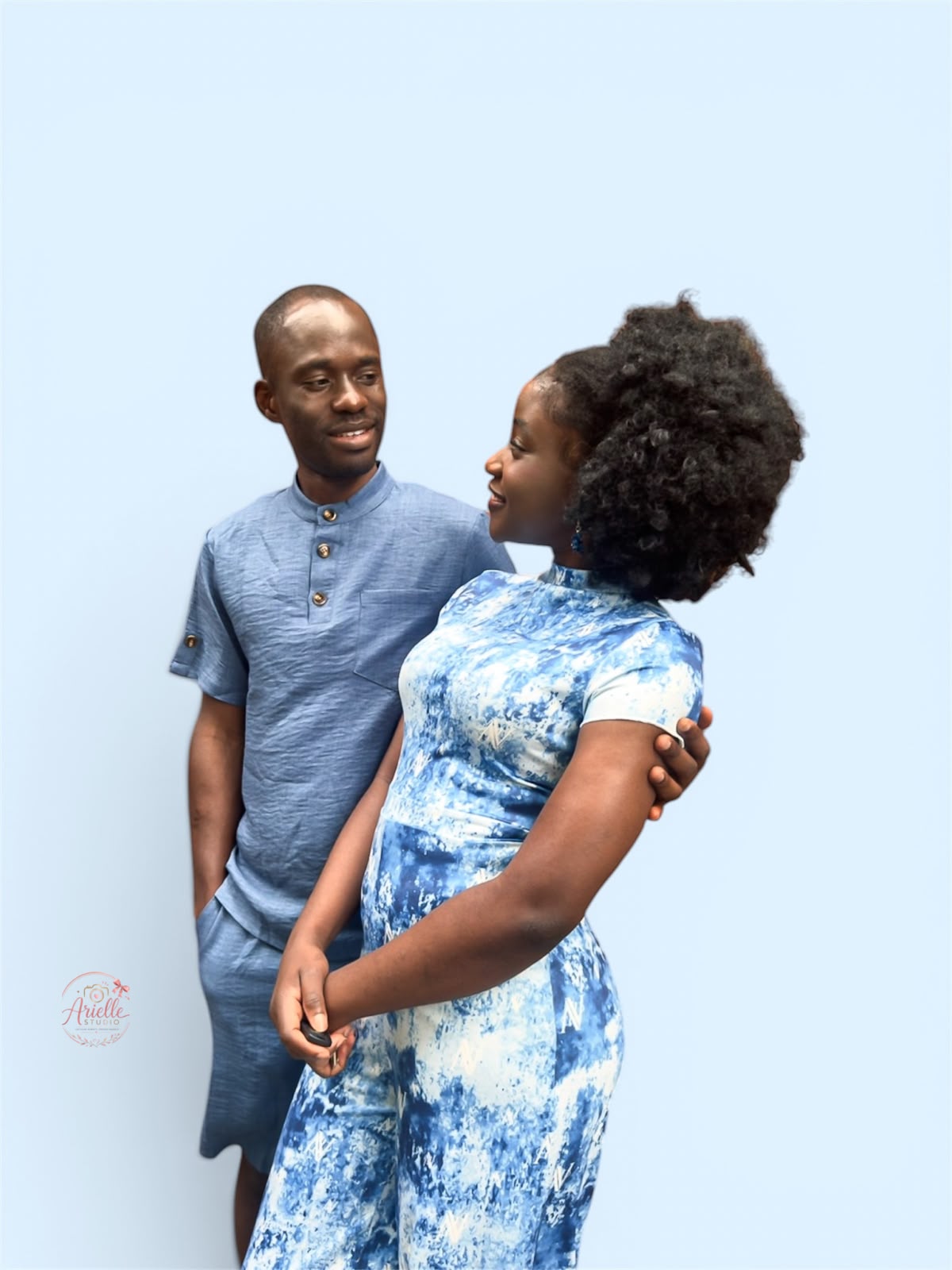 Busolami and Tunde looking at each other, hands held